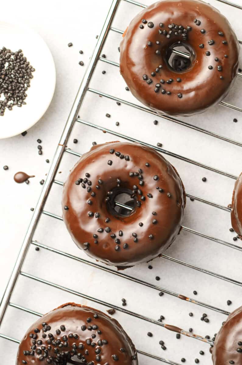 chocolate donuts on cooling rack