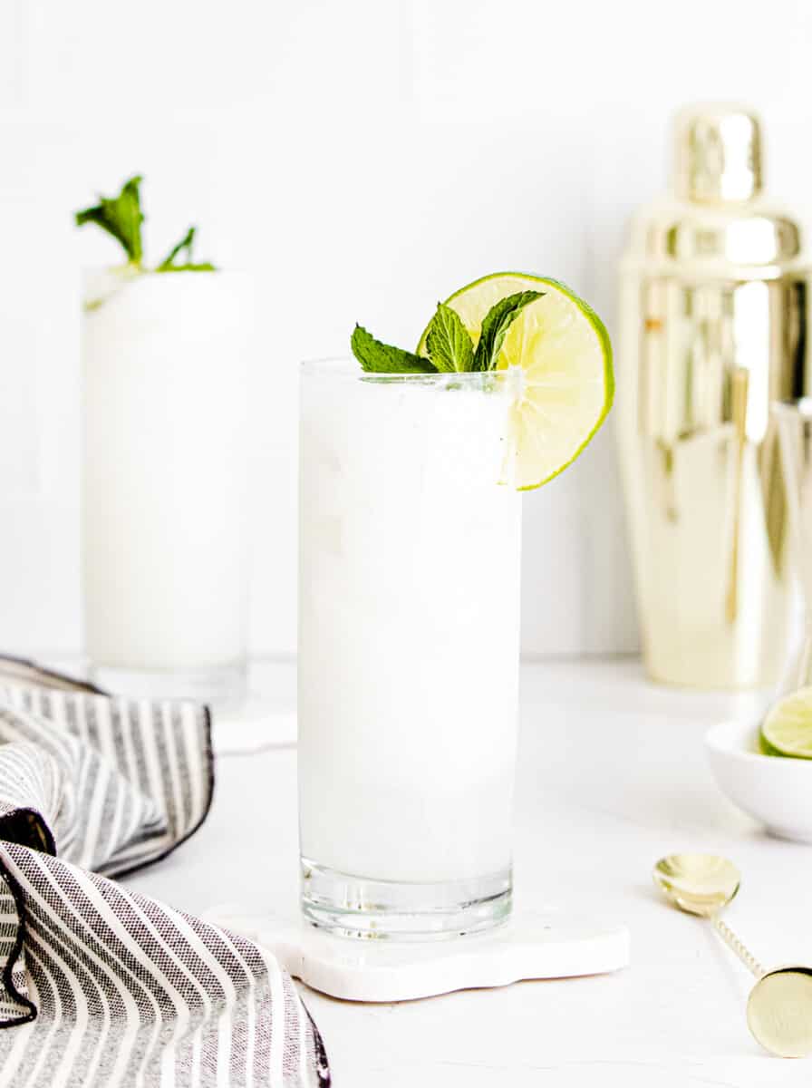 coconut mojitos garnished with lime and mint