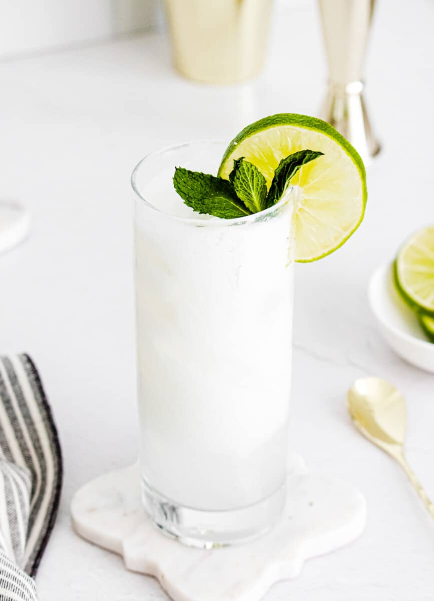 coconut mojitos garnished with lime and mint