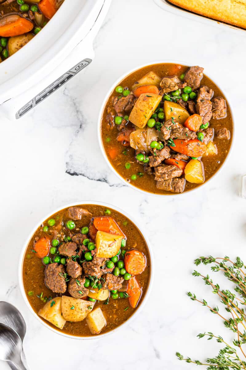 slow cooker beef stew in white bowls