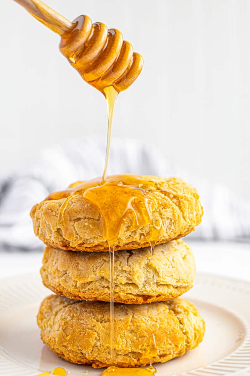 pouring honey over gluten free biscuits