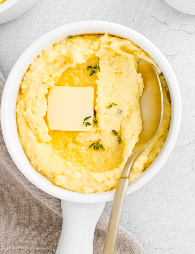 spoon digging into parmesan poletna