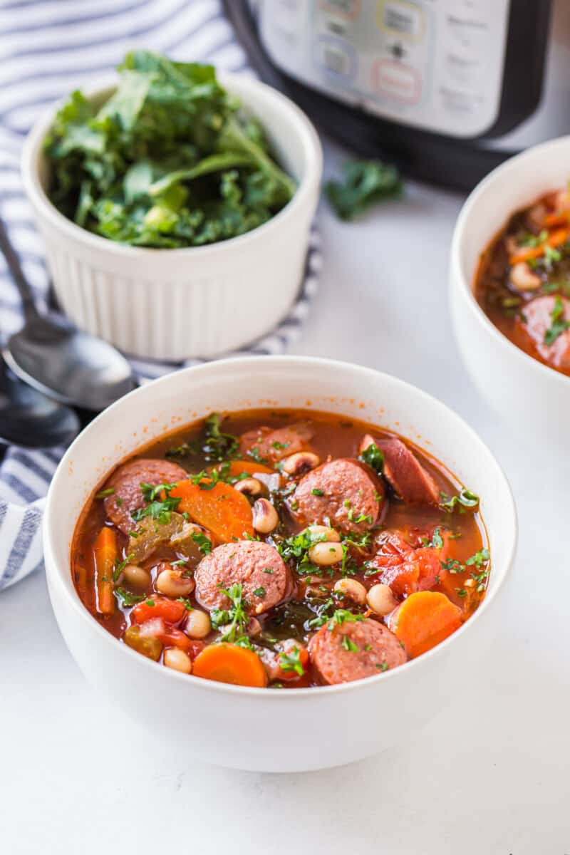 black eyed pea soup with sausage in bowl next to instant pot