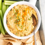 buffalo chickepea dip with chips and vegetables