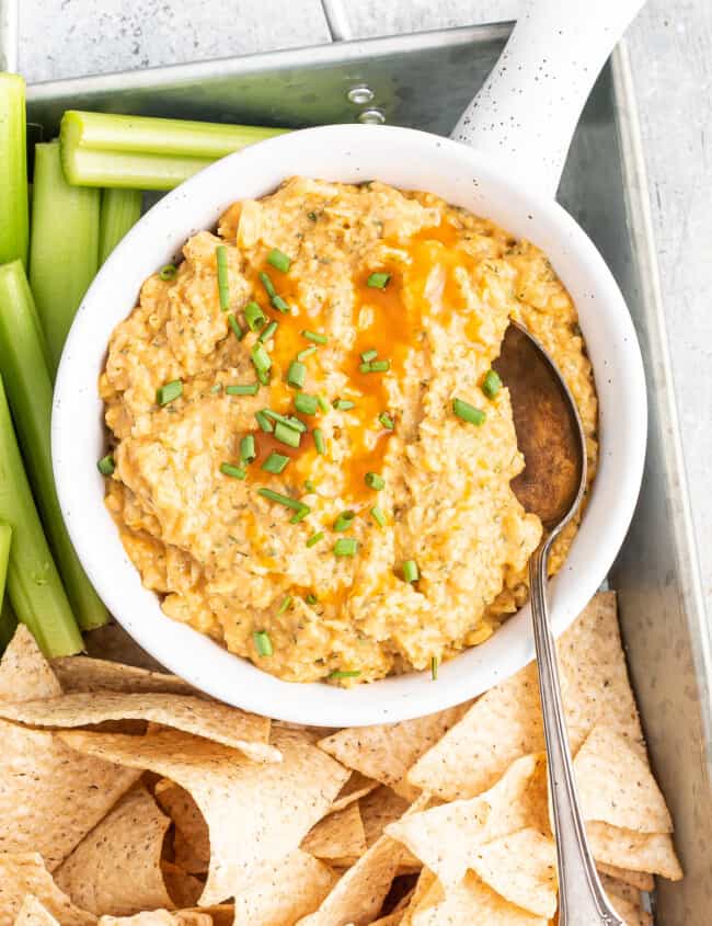 buffalo chickepea dip with chips and vegetables
