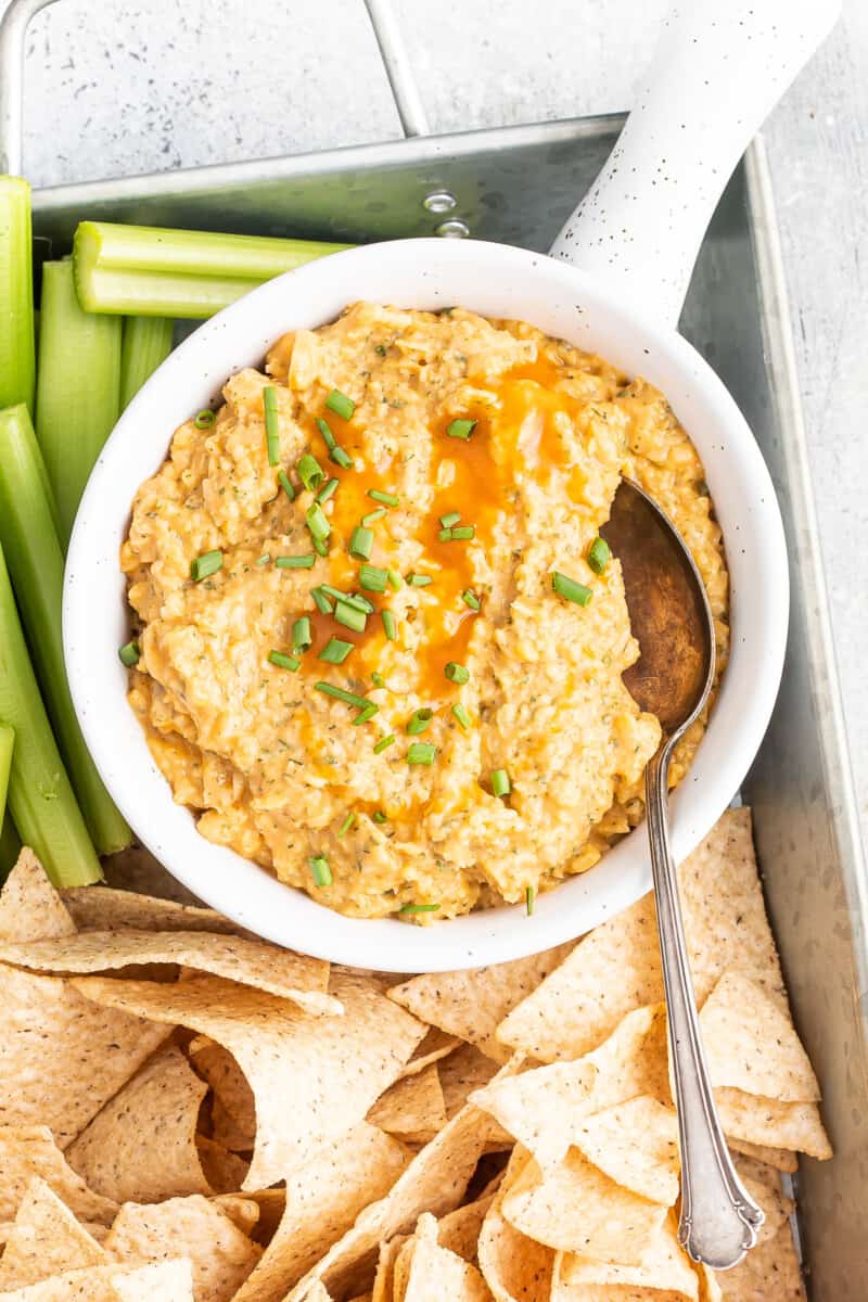 Buffalo chickpea dip with chips and vegetables.