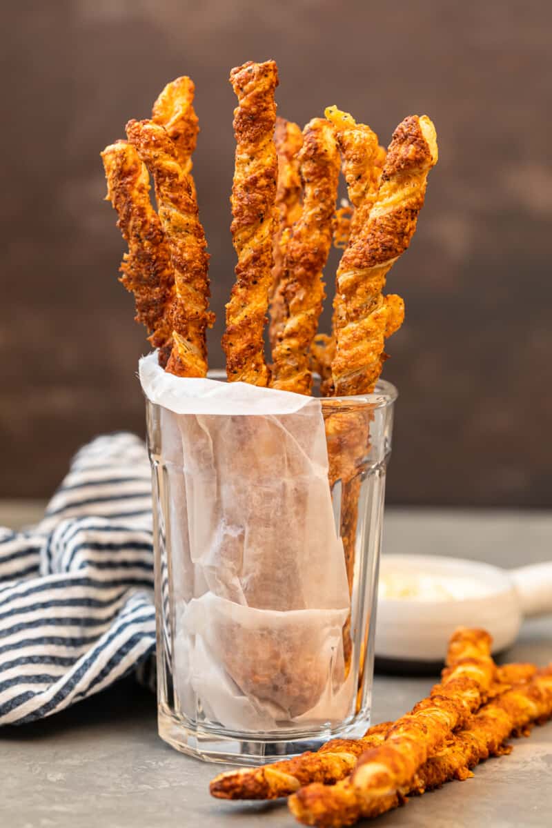 cheese straws stacked in glass