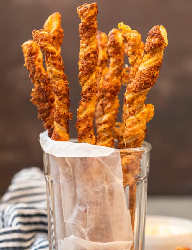 cheese straws stacked in glass