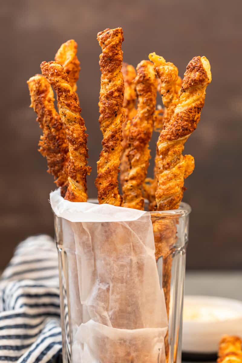 cheese straws stacked in glass