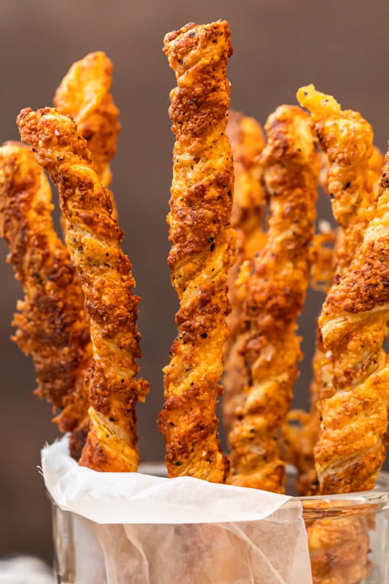 cheese straws stacked in glass