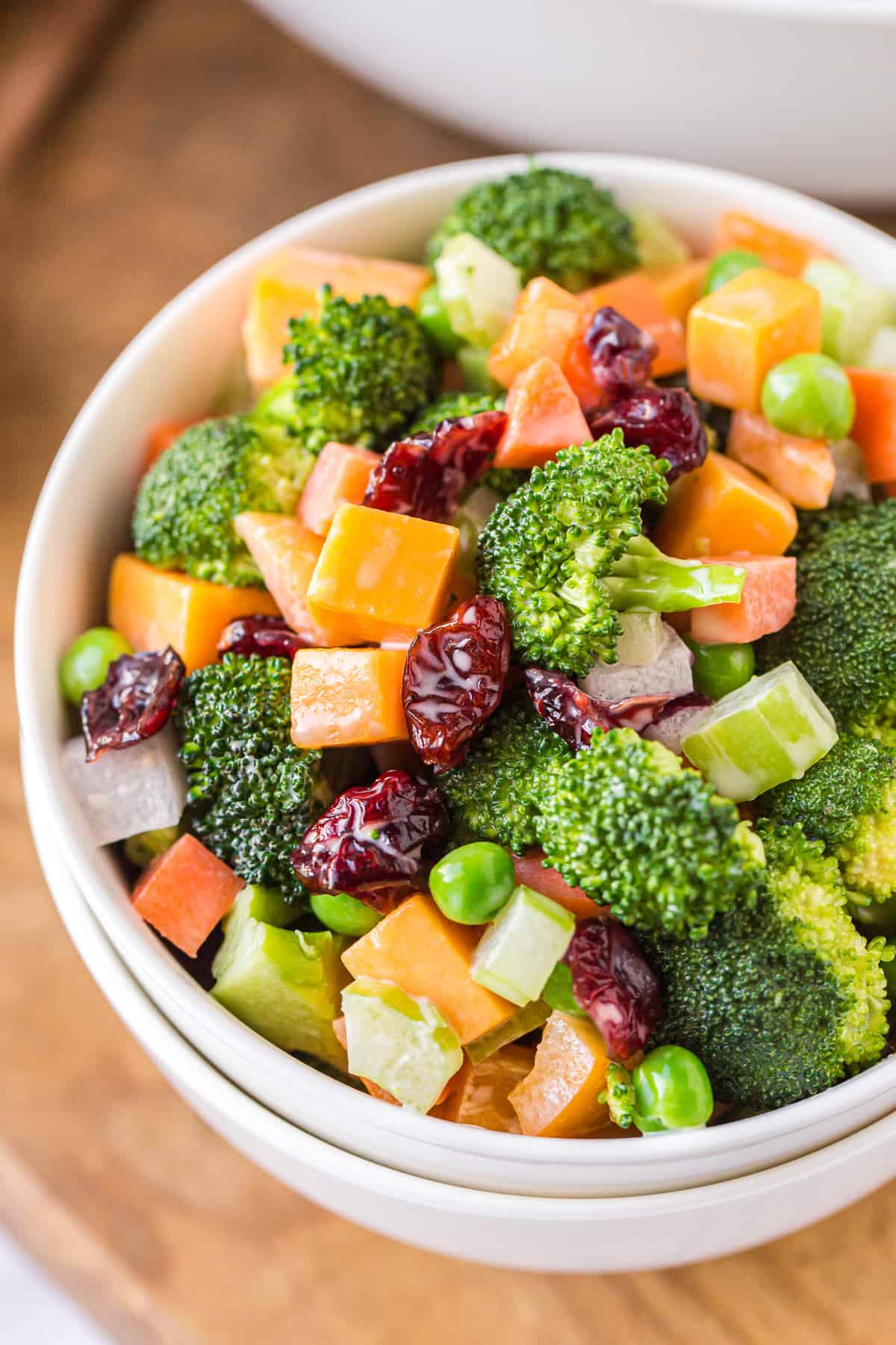 cheesy broccoli salad in white bowl