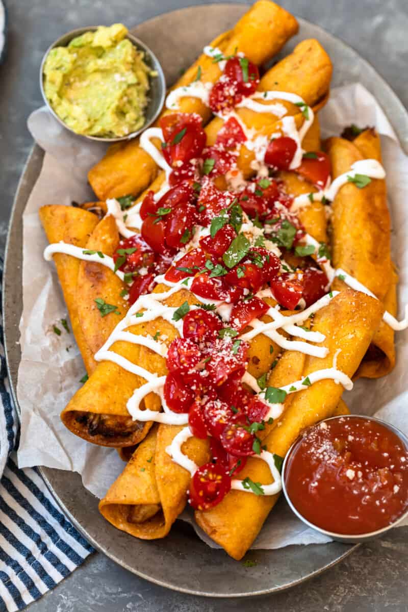 fried chicken taquitos garnished on platter