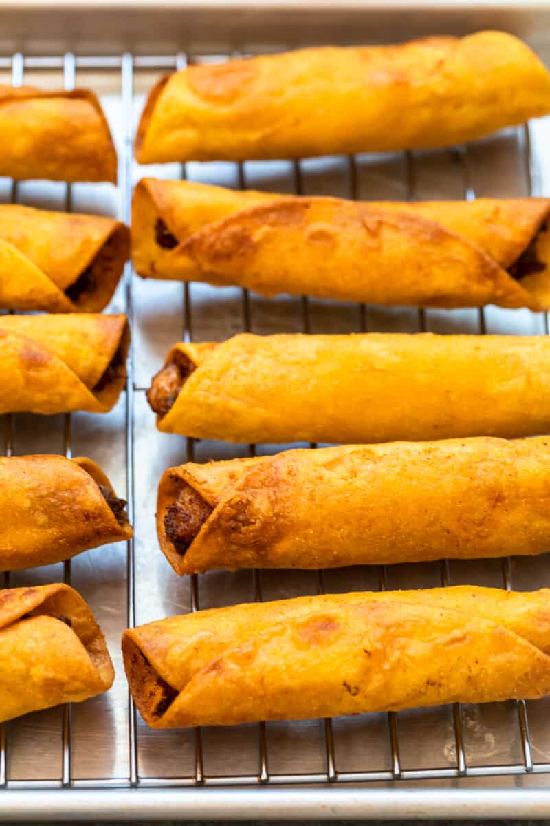 chicken taquitos on baking sheet to cool