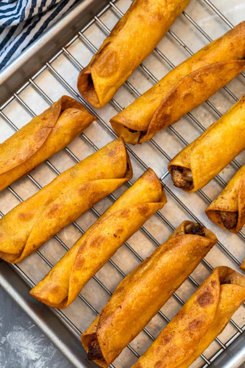 chicken taquitos on baking sheet to cool