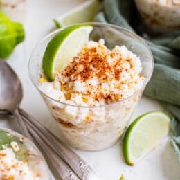 esquites in cups garnished with lime