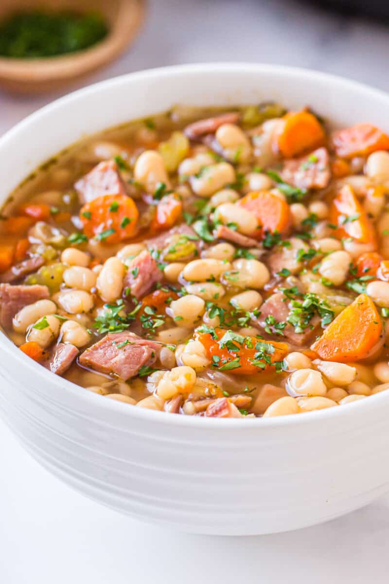 ham and bean soup in white bowl