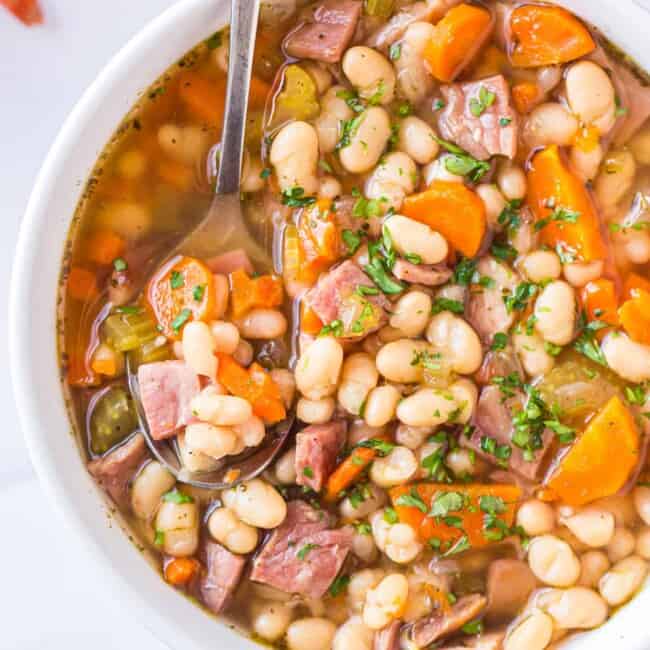 spoon in bowl of instant pot ham and bean soup