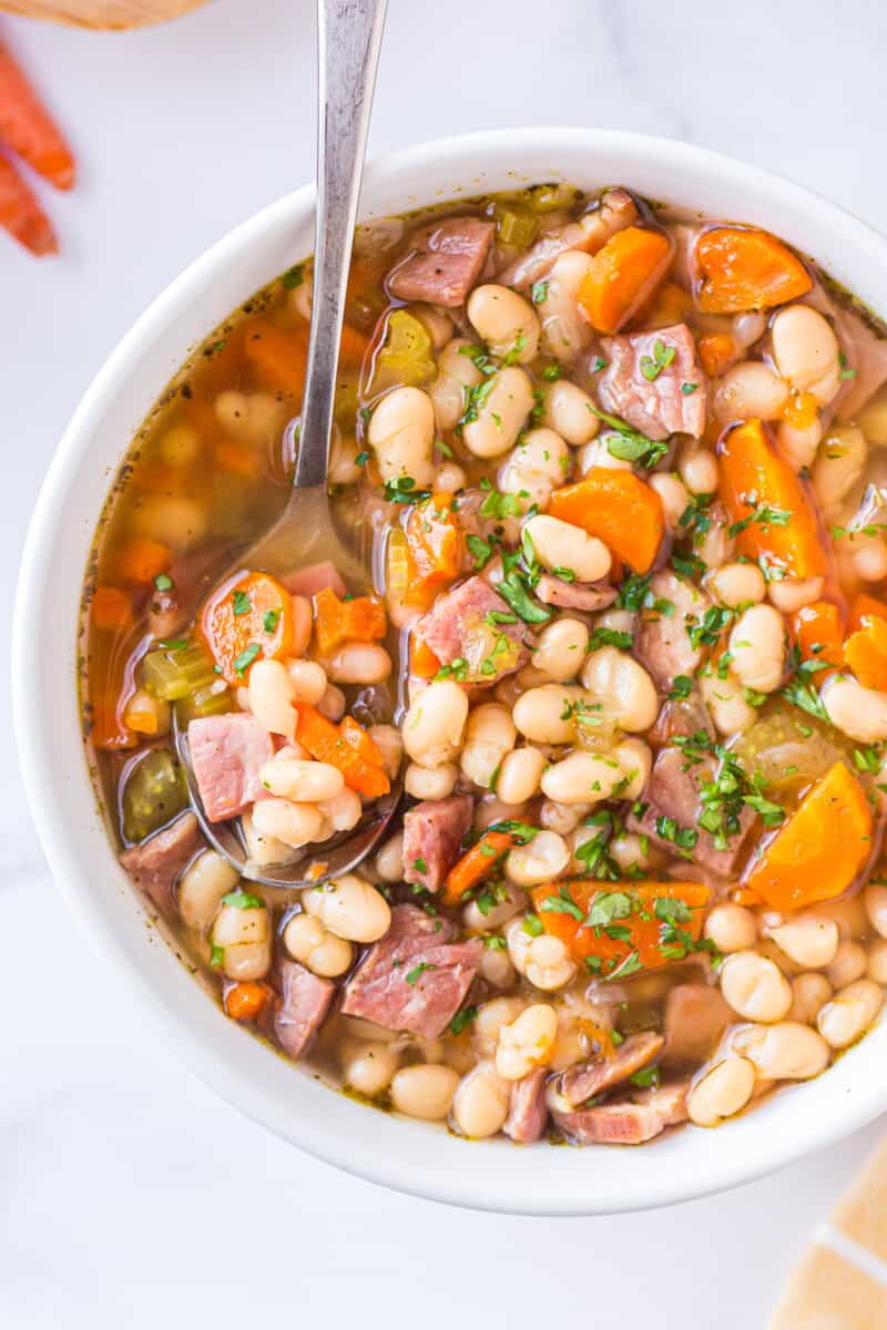 spoon in bowl of instant pot ham and bean soup