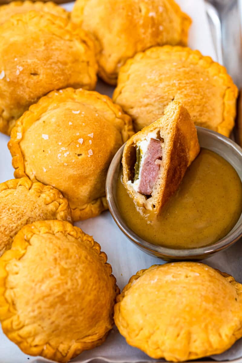 dipping kielbasa jalapeno popper bite in honey mustard