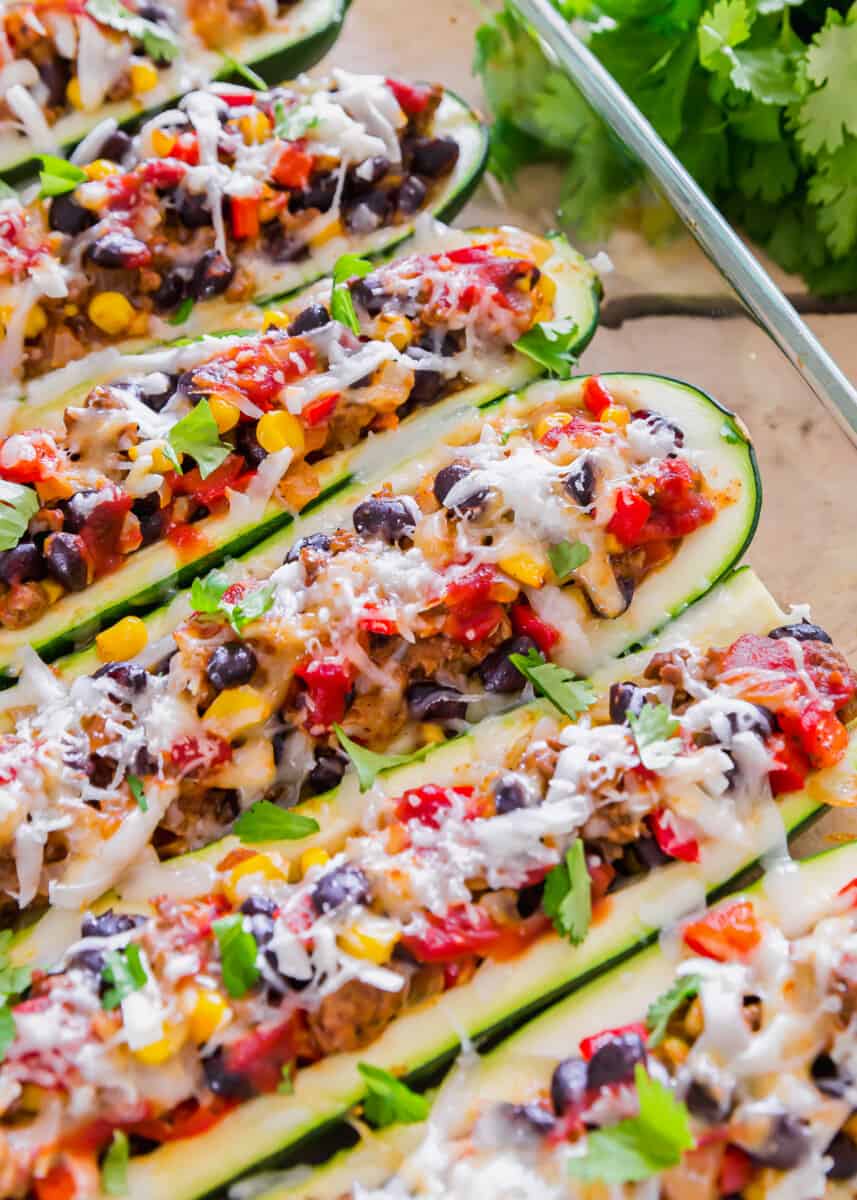 mexican stuffed zucchini boats garnished with cheese