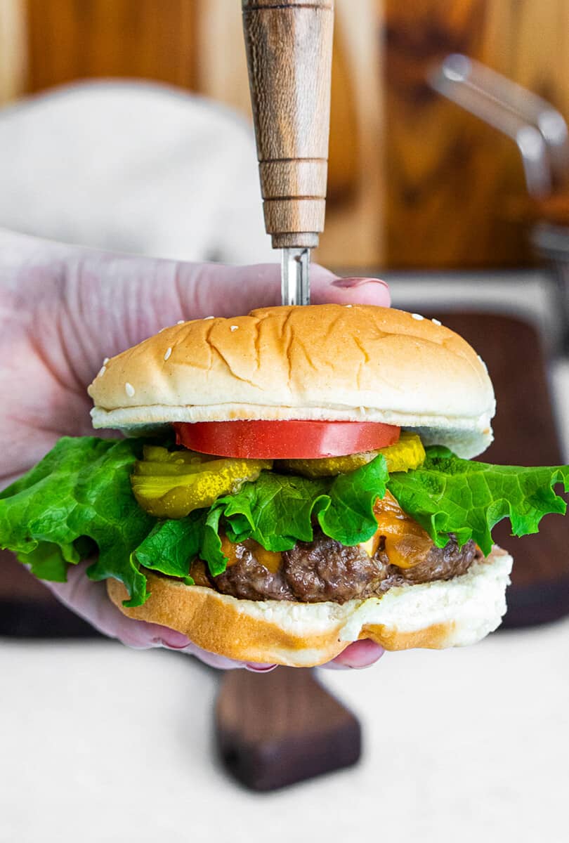 holding up air fryer hamburger