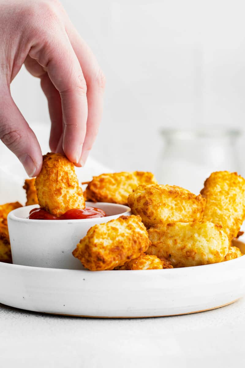 dipping air fried tater tot in ketchup