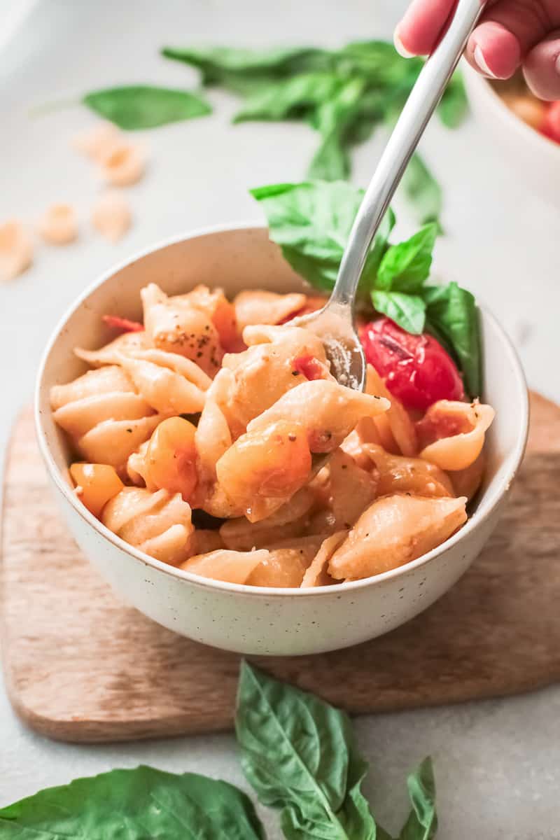 bowl of parmesan pasta with fresh basil