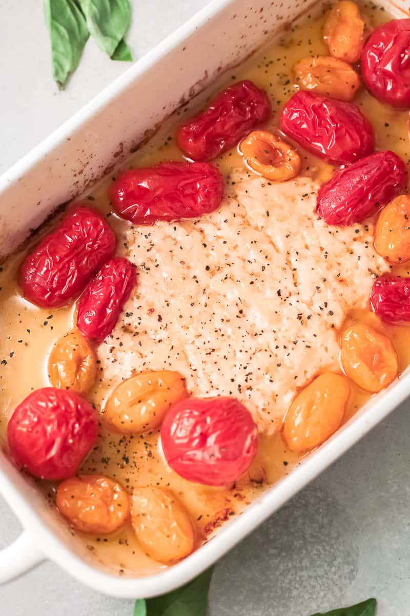 baking dish with baked parmesan and cherry tomatoes