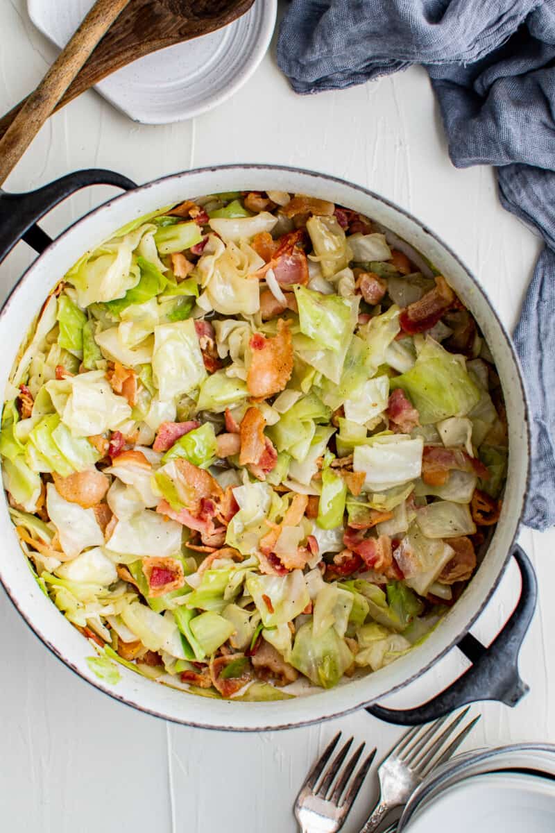 cabbage and bacon in blue dutch oven