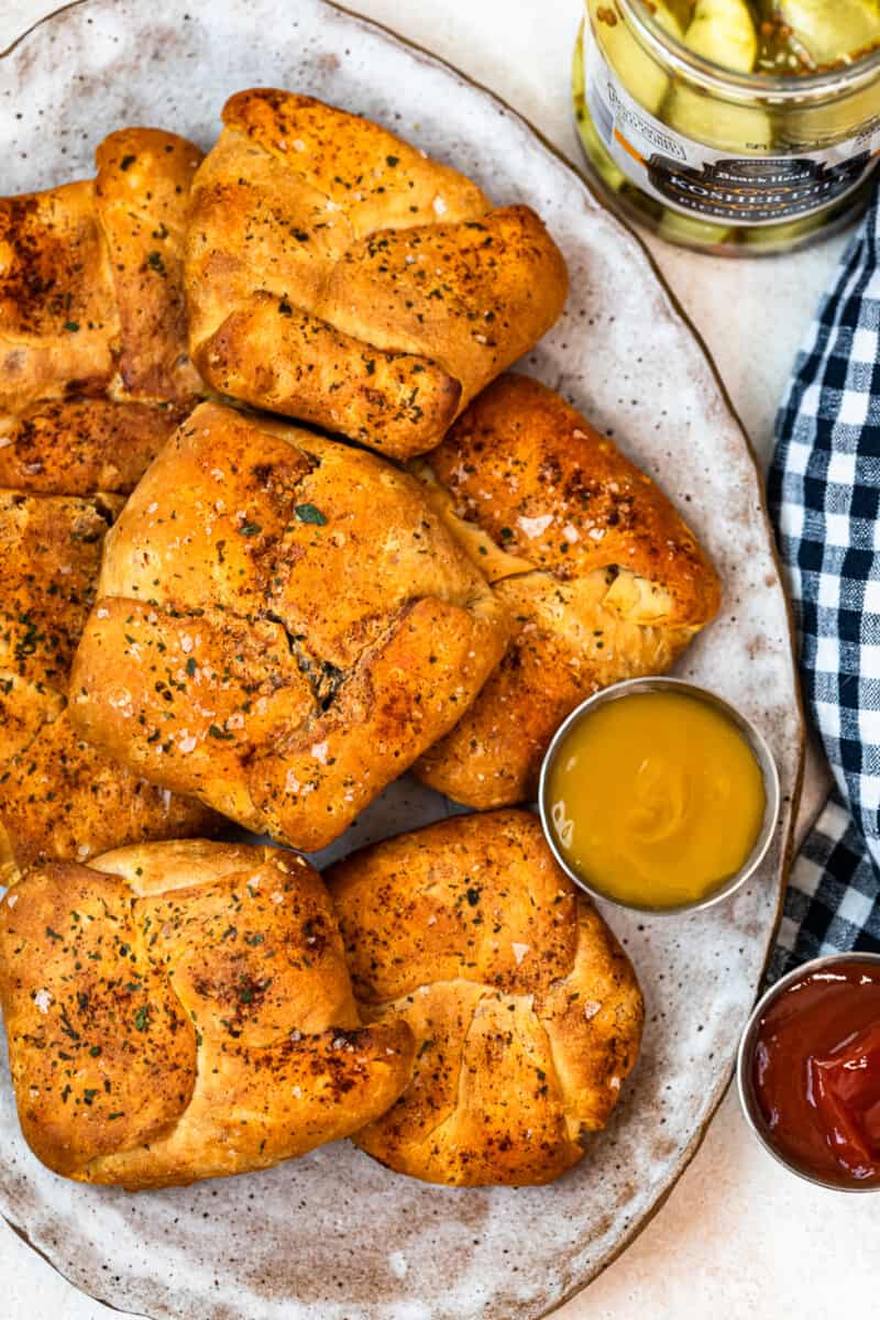 baked cheeseburger hand pies on white platter