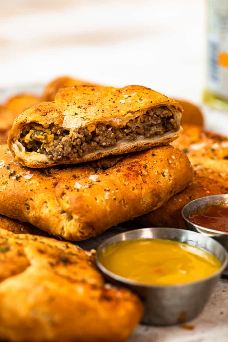 stacked cheeseburger hand pies on platter