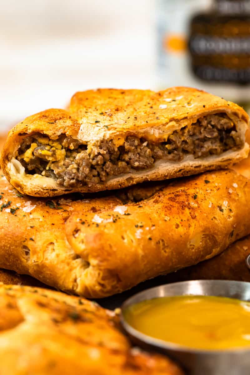 up close stacked cheeseburger hand pies on platter