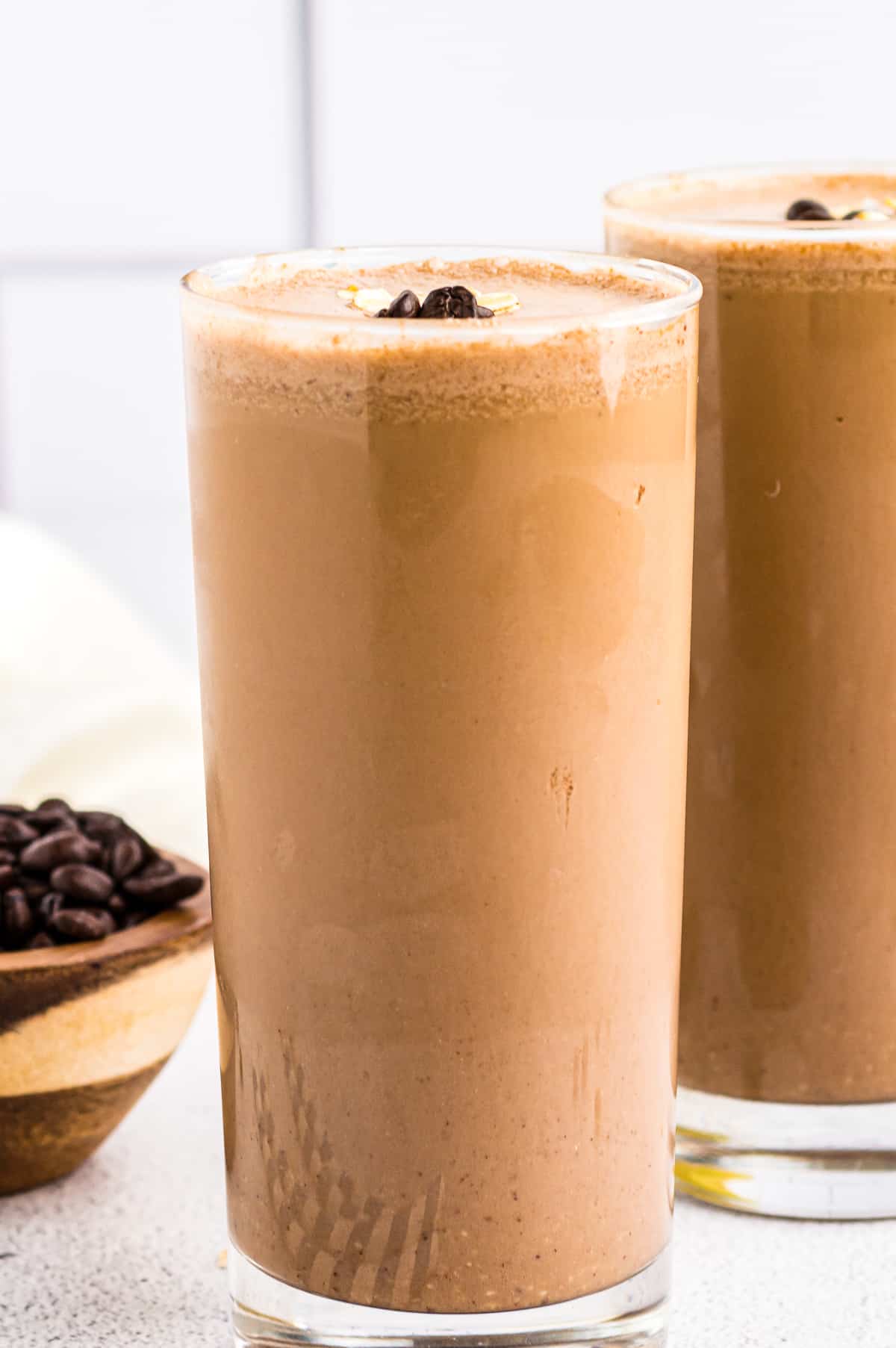 Two coffee smoothies in tall glasses. - 7