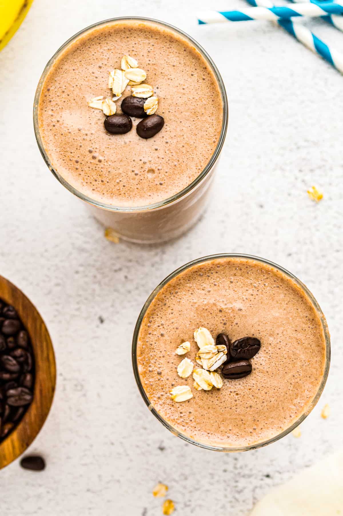 Two coffee smoothies garnished with coffee beans and oats. - 8