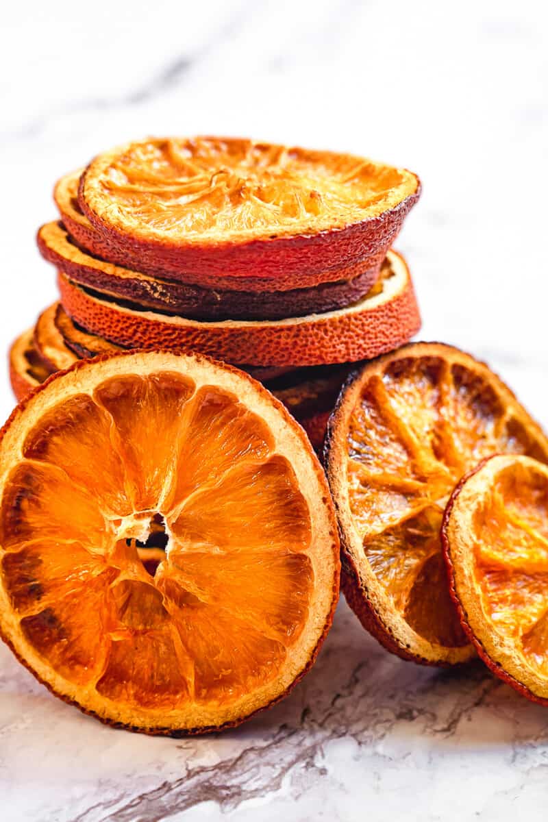 up close stacked dried orange slices on marble