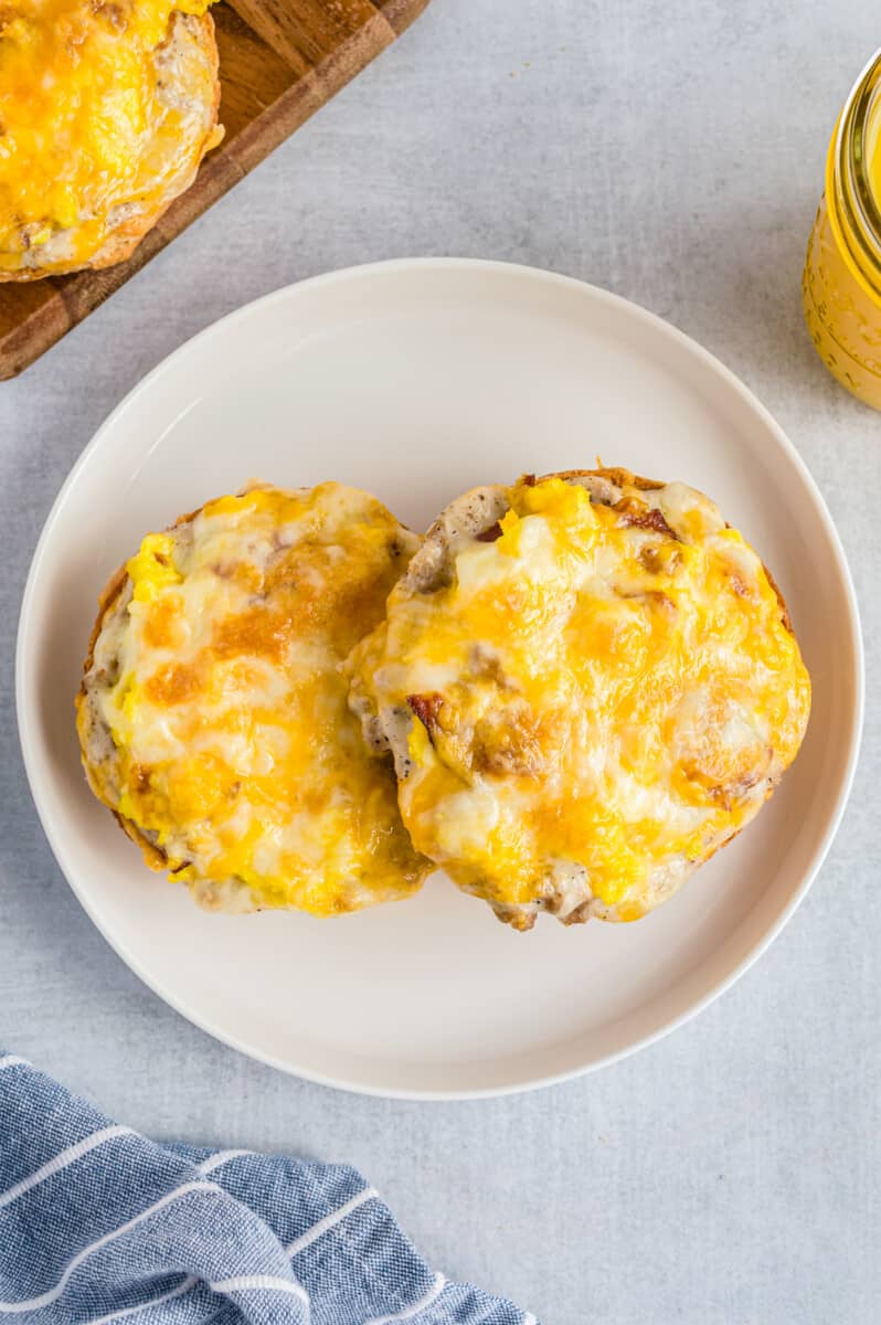 two english muffin breakfast pizzas on white plate