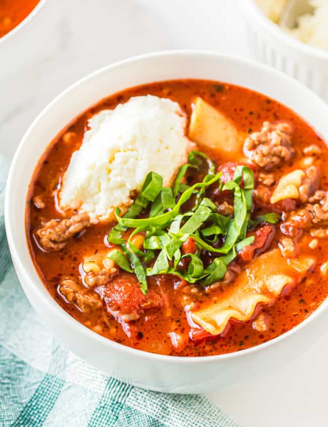 lasagna soup garnished with ricotta and basil