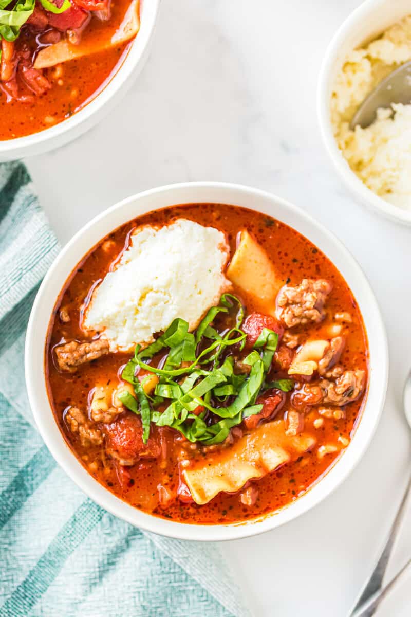 lasagna soup garnished with ricotta and basil