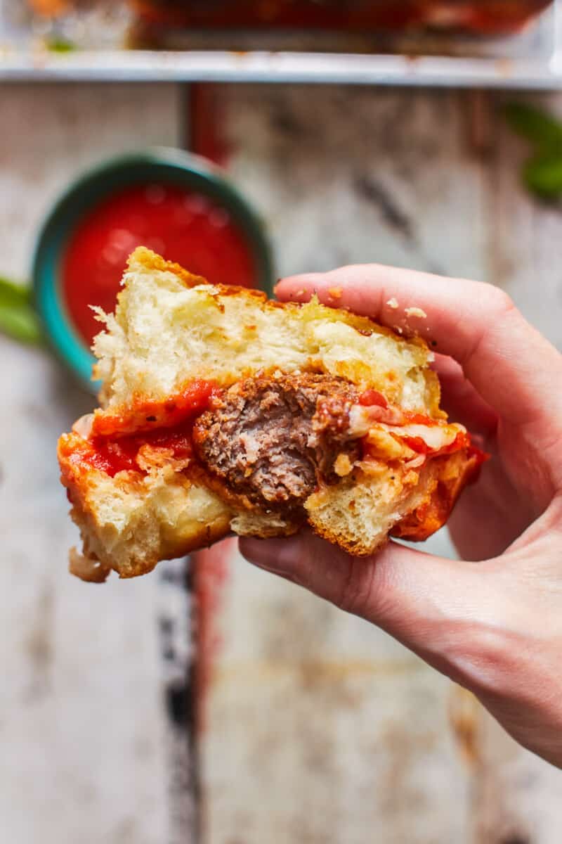 taking a bite out of a meatball slider