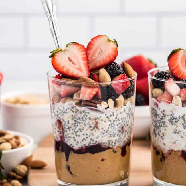 Peanut butter and jelly overnight oats in cup with spoon