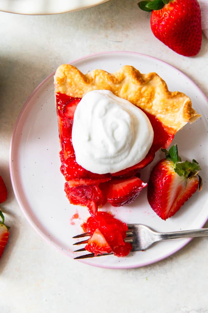 up close slice of strawberry jello pie with whipped cream