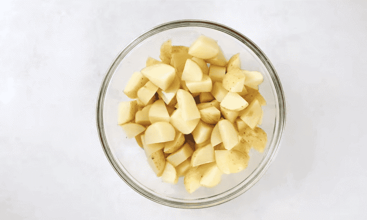 Cubed potatoes in a glass bowl.