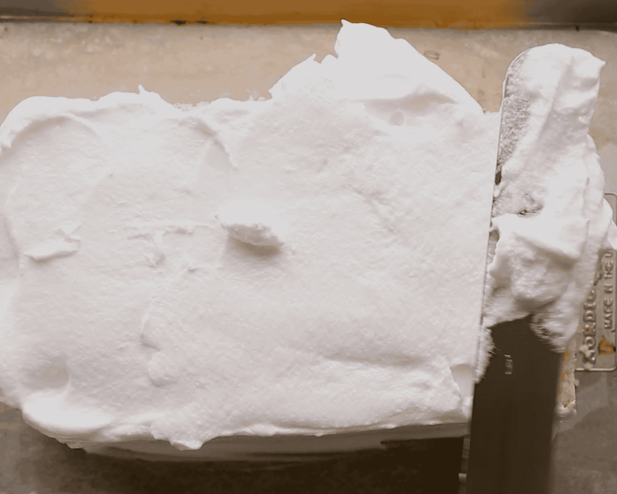 Covering the cake with meringue.