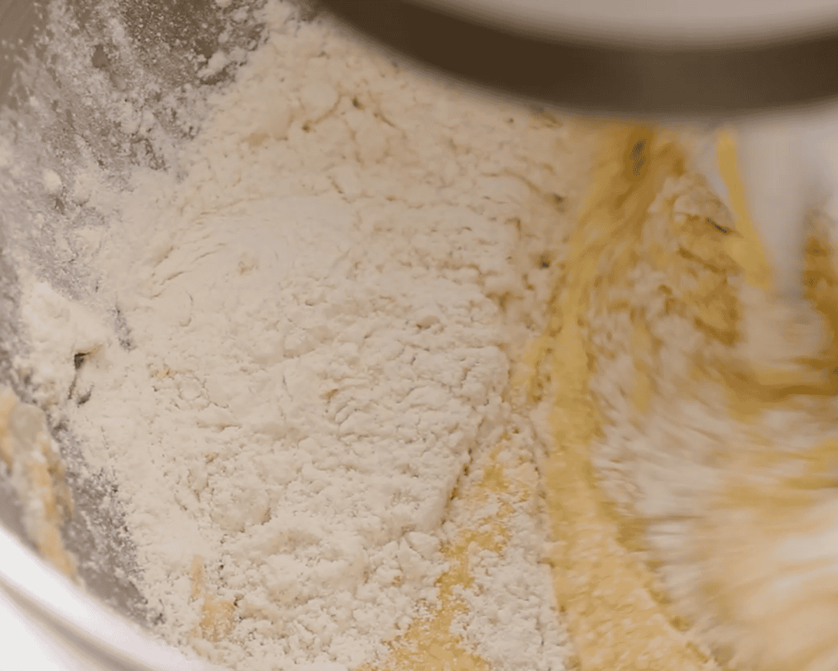Adding flour to the mixture.