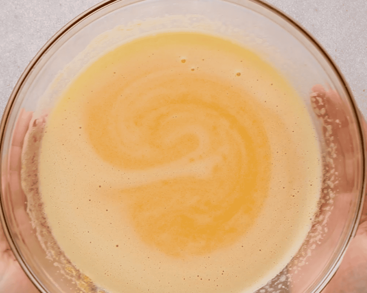 Lemon mixture and butter in a glass bowl.