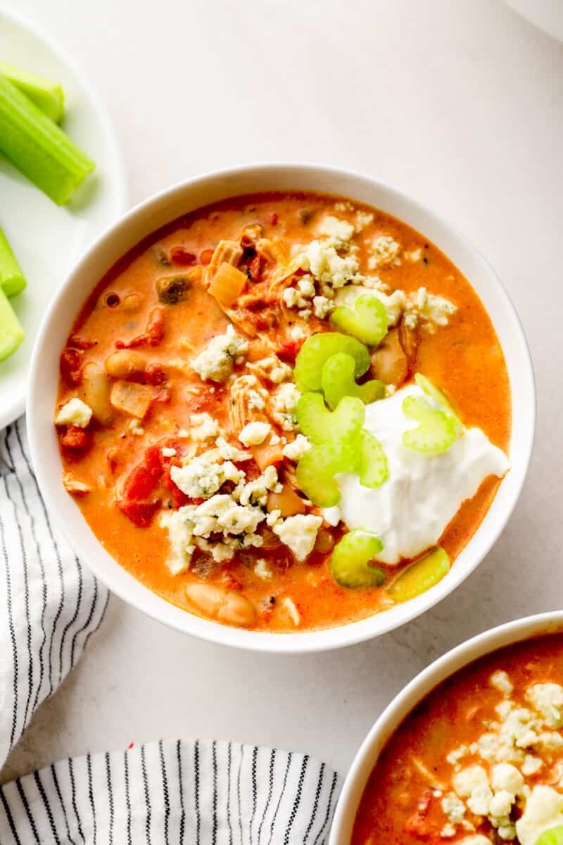 buffalo chicken chili garnished with sour cream, blue cheese, and celery