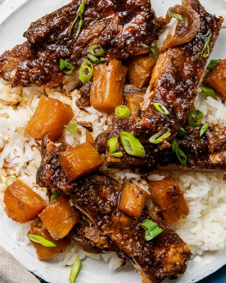 up close crockpot hawaiian ribs on plate over rice