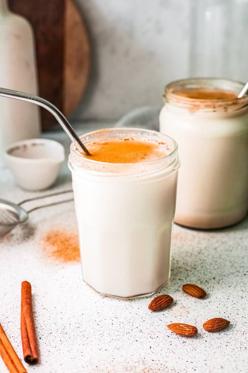 two glasses of horchata with metal straws