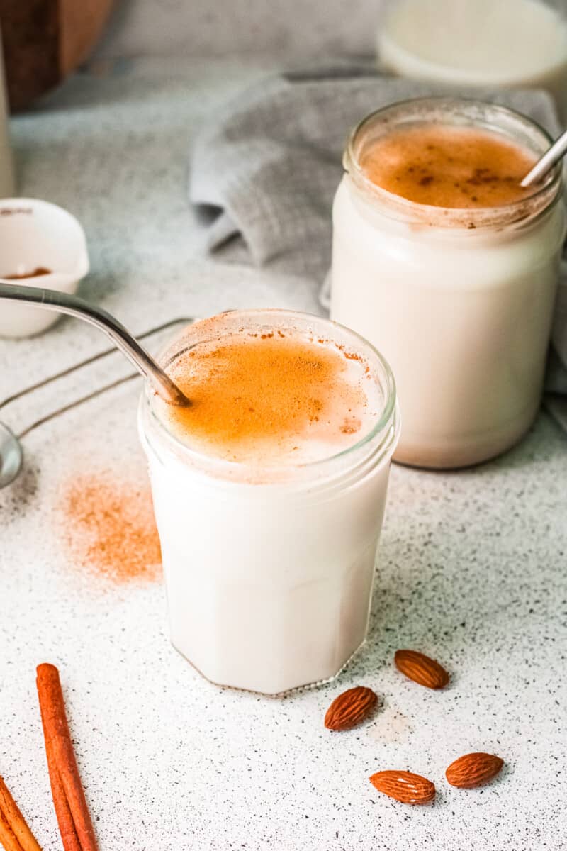 two glasses of horchata with metal straws