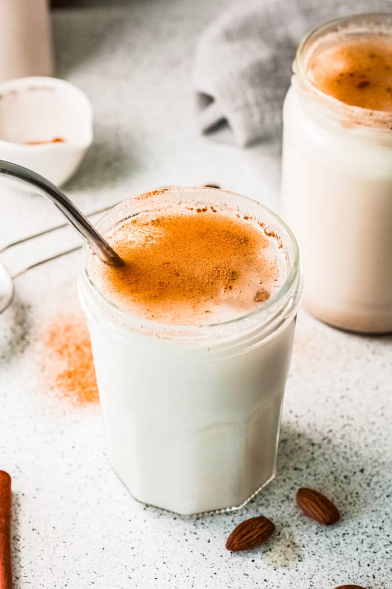 two glasses of horchata with metal straws